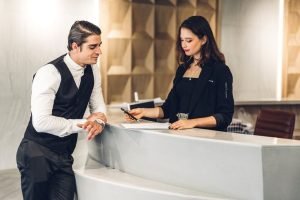 Young handsome businessman talking and check in Register informa